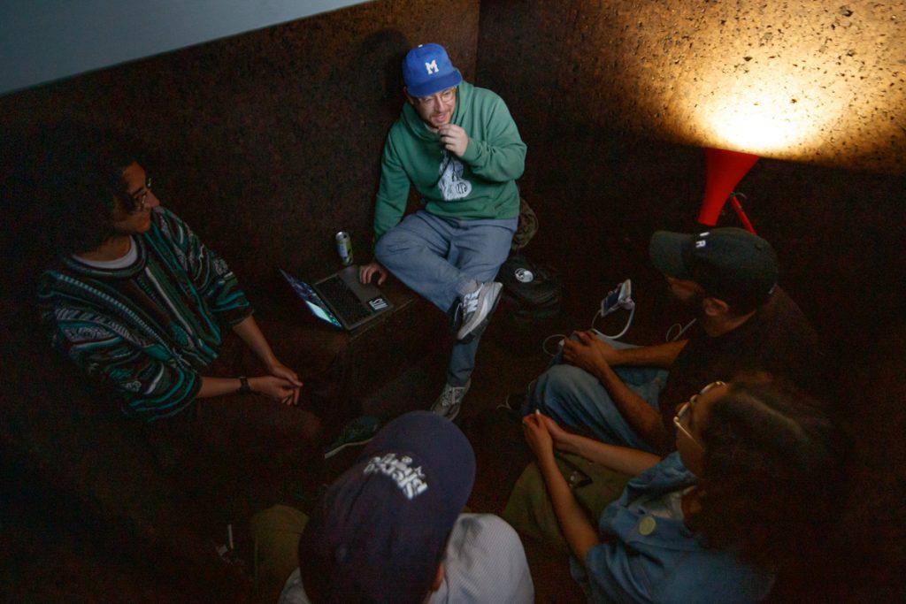 People recording a podcast in the Voicing Pod, from above